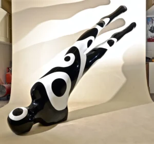 Black and white sculpture depicting a man suspended in mid-air, showcasing dynamic movement and artistic expression.