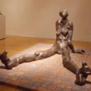 A sculpture depicting a woman seated on the floor, showcasing intricate details and a serene expression.