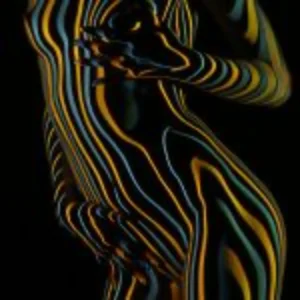 A radiant woman glowing in green and red, with her arms raised, symbolizing joy and vitality.