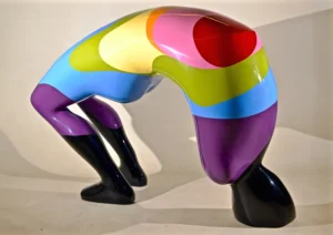 A vibrant sculpture depicting a woman bending over, showcasing intricate details and a dynamic pose.