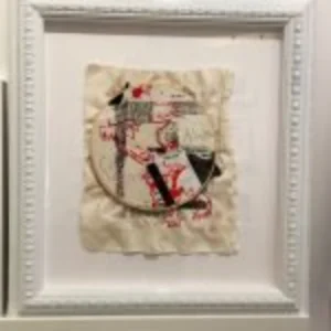 A framed artwork on a wall featuring a portrait of a person, showcasing their expression and personality.