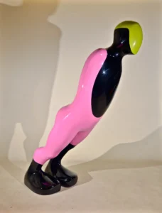 A pink and black figure with a yellow head, showcasing a unique and colorful design.